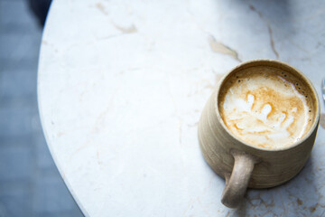 Coffee latte art on marble table.