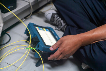 Technician Testing Network Cables with Device