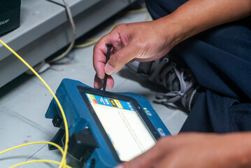 Technician Using Device for Data Analysis