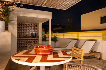A lovely patio features a table, chairs, and a bowl on it