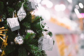 Closeup garland Christmas tree decoration,red,gold,silver ornament with bokeh background. Perfect holiday sales, winter celebration, festive seasonal promotions, marketing, shopping with copy space