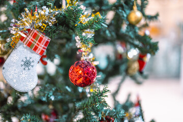 Closeup garland Christmas tree decoration,red,gold,silver ornament with bokeh background. Perfect holiday sales, winter celebration, festive seasonal promotions, marketing, shopping with copy space