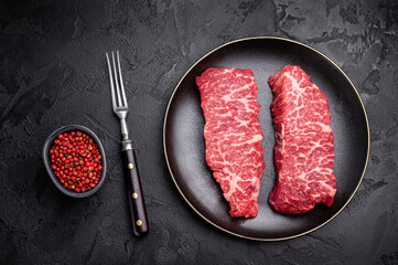 High-quality Denver cut, featuring a perfect balance of fat and meat steak. A great choice for those seeking a flavorful and juicy steak experience. black background. top view