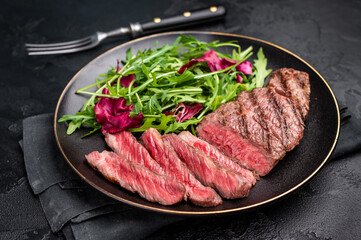 Succulent Denver cut, showcasing a perfect sear and rich color after grilling. black background. top view