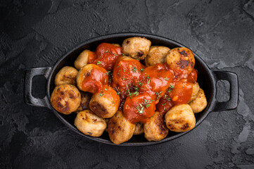 Hearty meatballs, beef balls, bursting with flavor and served in a rich tomato sauce. A beloved dish that combines tradition and taste for every occasion. black background. top view