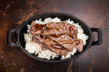 Exquisite Japanese BBQ, highlighting beautifully charred meats and rice. Perfectly seasoned, this dish promises a rich and savory flavor in every bite. brown background. top view