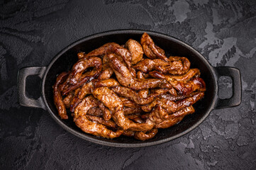 Korean Beef  Meat Bulgogi Hot Plate. black background. top view