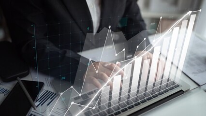 A business professional analyzes stock market trends using digital data visualization on a laptop in a modern office, showcasing financial insights and growth potential. Copula
