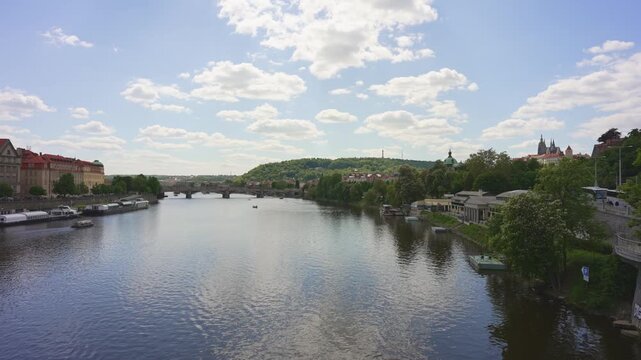 Scenic Vltava River view with Petrin Hill.