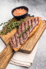 Grilled  Top Sirloin, cooked rump beef steak. grey background. top view
