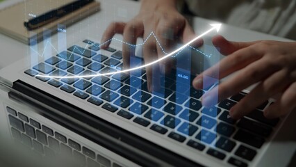 Hands actively typing on a laptop keyboard overlayed with a digital upward trend graph. The image symbolizes business growth, analytics, and technology in a modern work environment. Copula