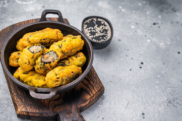 Korean Crispy seaweed noodle rolls Gimmari deep-fried seaweed rice rolls. grey background. top view