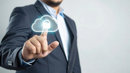 A businessman touches a digital cloud icon, symbolizing data security and cloud computing technology.