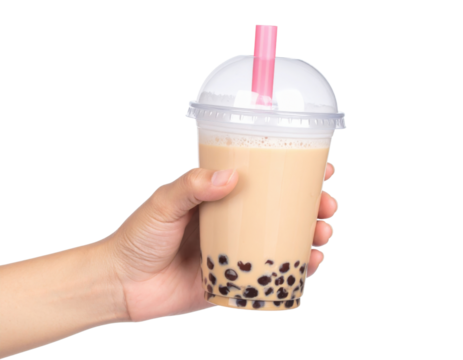 A hand is holding a plastic cup of refreshing bubble tea with dark tapioca pearls and a pink straw, isolated on a transparent background.