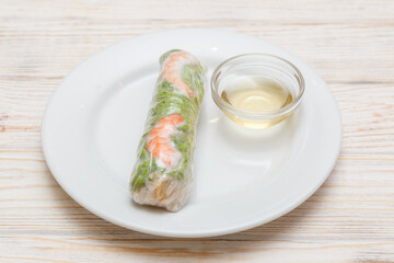 Rouleau de printemps avec Nuoc Cham sur assiette blanche. Cuisine vietnamienne. Traiteur vietnamien.