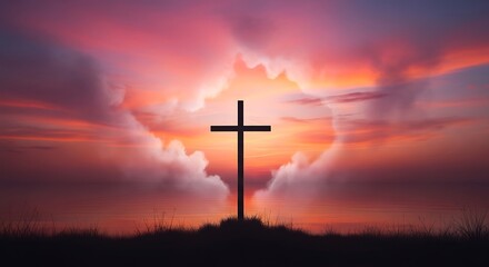 Silhouette of a christian cross against a dramatic, vivid sunset sky with glowing clouds