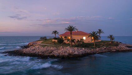 Sitting single detached villa with red tile roof showing warm window glow at dusk, with palms
