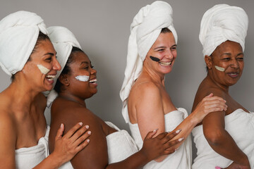 Group of happy multiracial women having fun together during beauty skin care day - Face treatment, multi generational people and friendship concept