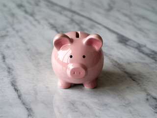 Adorable pink piggy bank gleaming on marble, perfect for finance blogs, investment guides, or promoting savings goals with a touch of playful charm