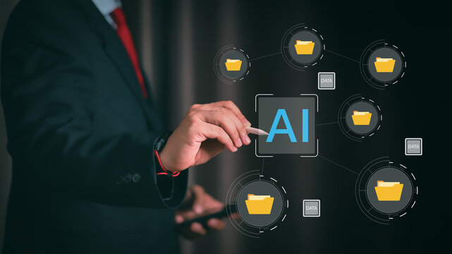 Businessman using pen to touch AI artificial intelligence icon on virtual screen with document file folders. Concept of smart data management and digital storage automation system.