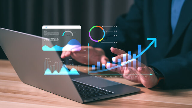 Businessman analyzing financial growth chart with rising arrow on laptop. Concept of business success, digital data analysis, stock market profit and economic investment strategy.