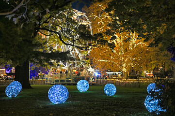 Big blue shiny balls Christmas decorations and Ferris wheel in the park Rathaus, Vienna. Austria