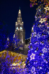 Christmas tree and Rathaus tower in Vienna at night, Austria