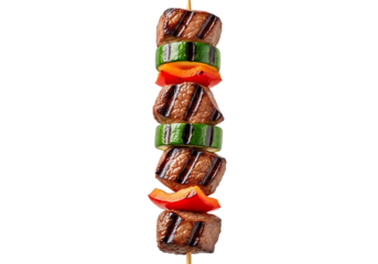A perfectly grilled beef and vegetable skewer featuring seared meat cubes alternating with zucchini and red bell pepper pieces, isolated on transparent background