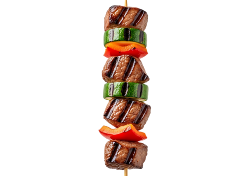A perfectly grilled beef and vegetable skewer featuring seared meat cubes alternating with zucchini and red bell pepper pieces, isolated on transparent background