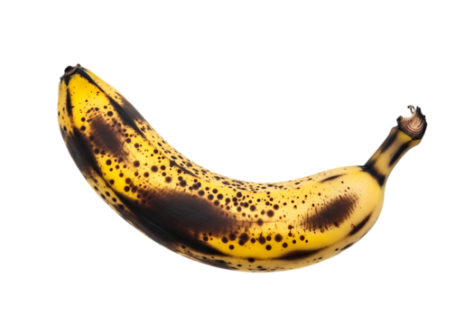 A ripe yellow banana with numerous brown and black spots, isolated on transparent background