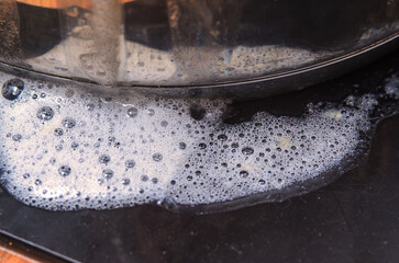 Close-up of soapy bubbles and foam on a dark surface, abstract texture