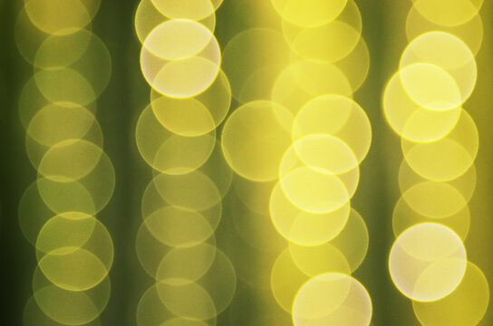 abstract yellow bokeh lights background with blurred round shapes