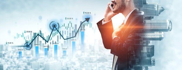 A confident businessman in a suit uses a smartphone, standing beside a financial growth chart that...