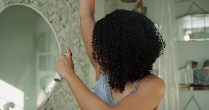 Bathroom, grooming and woman with spray, deodorant and body care with product for underarm or smell. Armpit, hygiene and African person with antiperspirant for bad odor prevention, skincare and home
