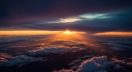 Breathtaking view from above the clouds during a dramatic sunset with intense golden sun rays shining through