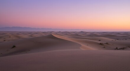 The soft, pastel colors of dawn over the desert.