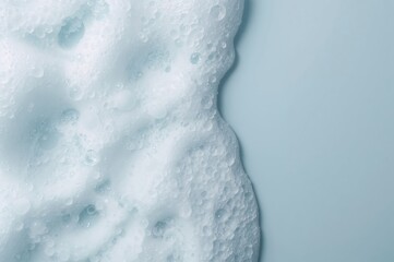 Obraz premium Soft white foam catches gentle morning light in a serene pale blue setting