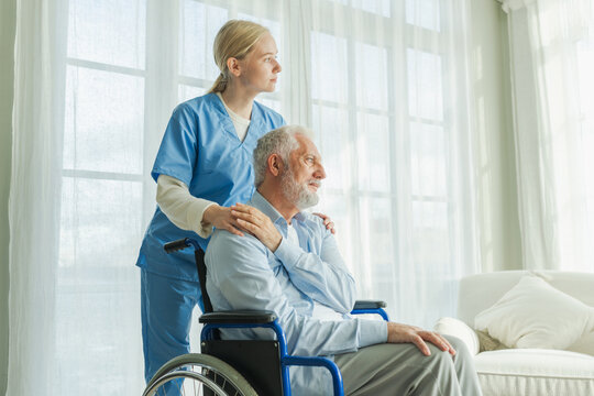 Help support retirement healthcare. Nurse helping old man in wheelchair. Patient and woman in nursing home for medical caregiver. Nurse taking care of paralyzed man in chair for people with disability