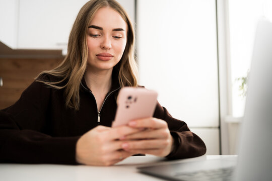 Accountant or business woman using smartphone to relax use chat business communication working online at home.