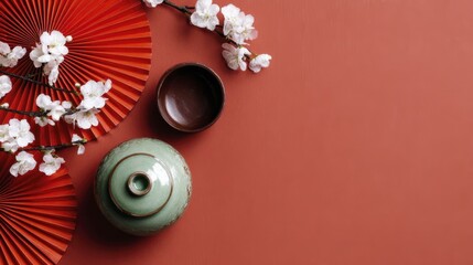 Japanese tea ceremony elements with red fans and blossoms on minimalistic background