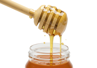 Close-up of a wooden honey dipper lifting and dripping a thick, golden stream of natural honey into a clear glass jar, isolated on a transparent background. Concept of natural sweetness and purity