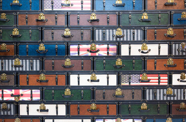 A wall made of a large number of antique chests.