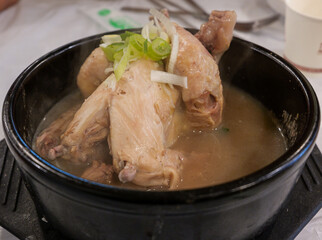 Steaming Samgyetang Ginseng Chicken Soup in Black Bowl