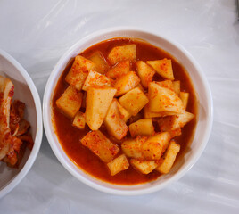 Kimchi and Kkakdugi Side Dishes in Ceramic Bowls