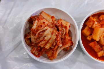 Kimchi and Kkakdugi Side Dishes in Ceramic Bowls