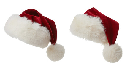 Two traditional red velvet Santa Claus hats with fluffy white trim and pompoms, isolated on a white background.