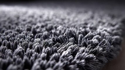 Close-up view of a grey, shaggy, textured surface. Focus on details and depth - Powered by Adobe