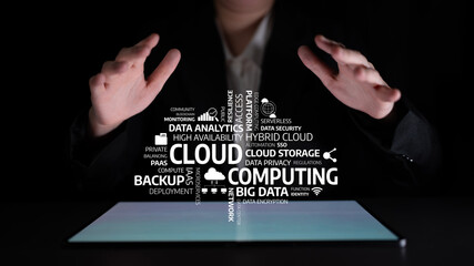 A conceptual image depicting hands reaching toward a digital display with cloud computing terms. This visual represents modern business solutions in technology and data management. Tessel