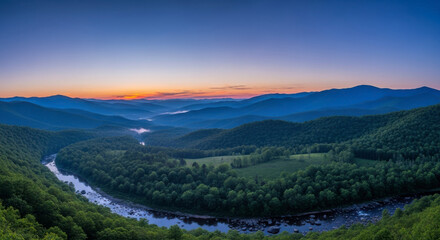 Sunrise over a beautiful meandering river in a forested mountain valley