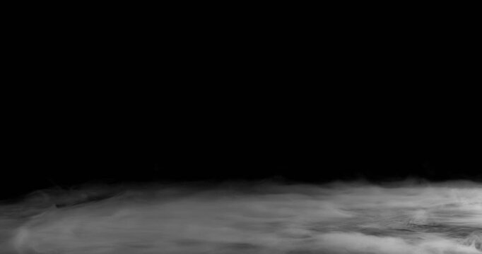 Super Slow Motion of White Surface Smoke Texture Isolated on Black Background. Filmed on High Speed Cinema Camera, 500fps. VFX element for overlay.